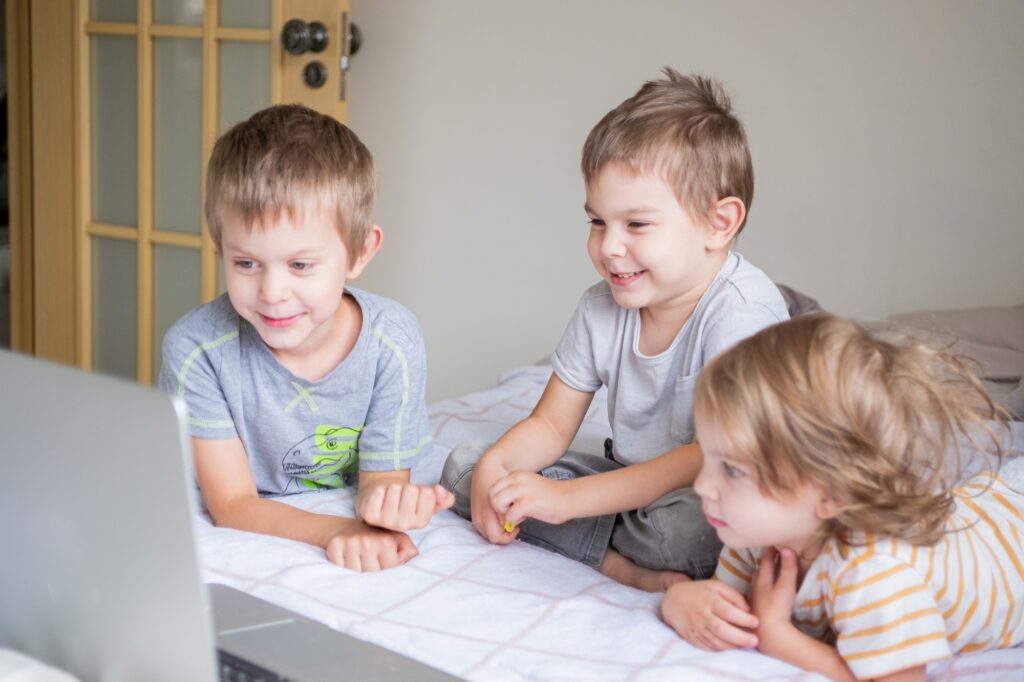 Little kids with laptop. Brothers and sister. Kids with technology